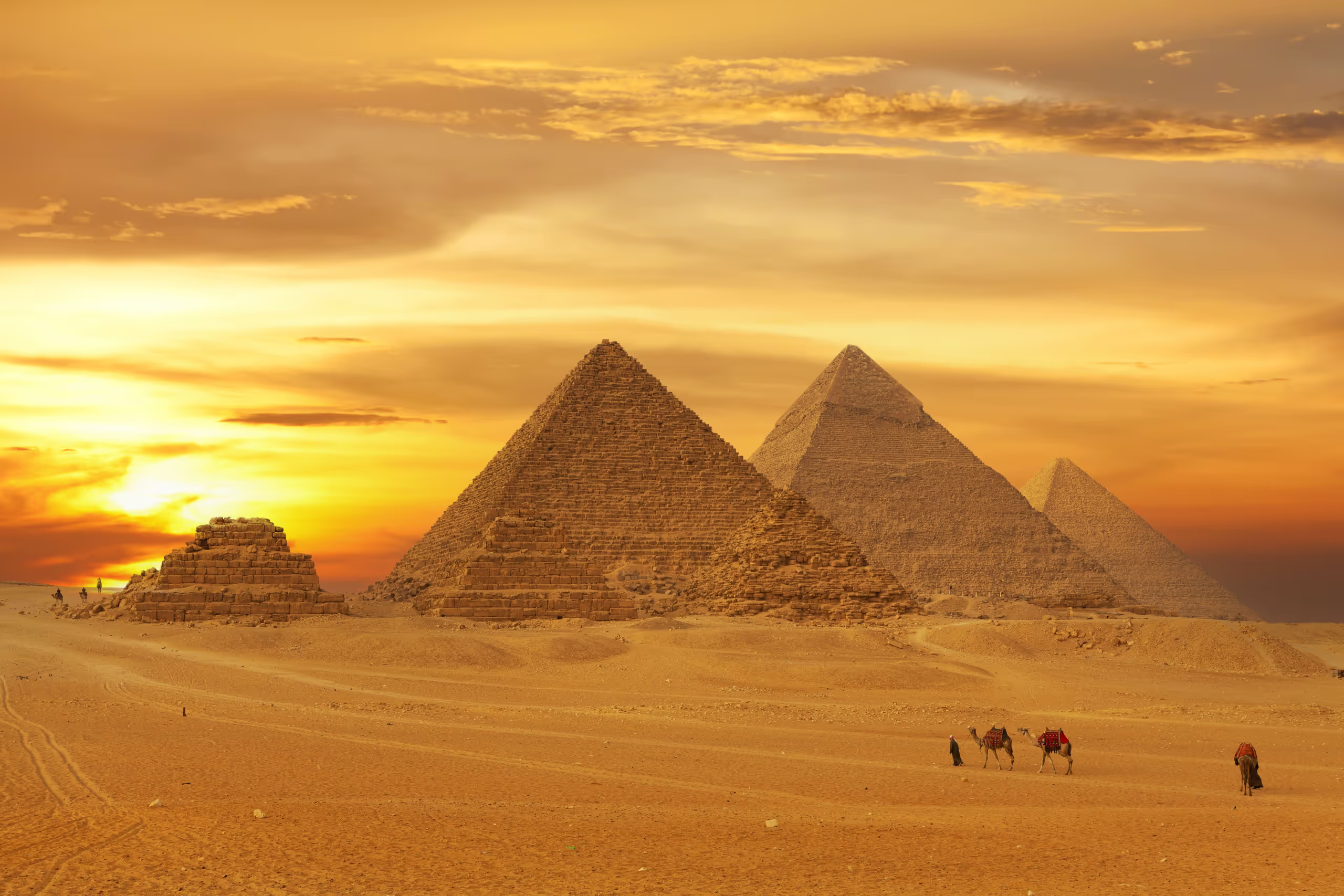 The Great Pyramids of Giza beneath a golden sky